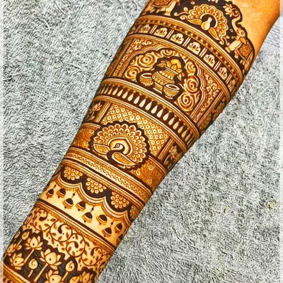 A detailed forearm band featuring traditional Indian motifs like the kalash (pot) and peacocks, perfect for any festive occasion.