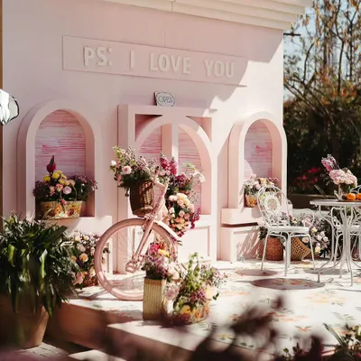 For a bride who loves street markets, I designed this 'Parisian Market' Mehendi. This 'PS I Love You' photo booth, complete with a flower-filled bicycle, became the perfect spot for romantic and whimsical pictures.