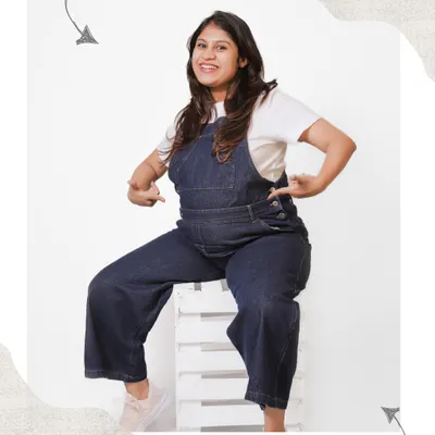 A fun and playful solo portrait of a mom-to-be in denim dungarees. This casual style is perfect for showing off your personality and the happy excitement of pregnancy.