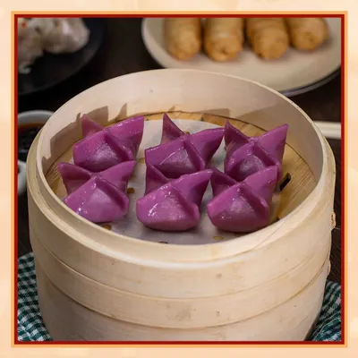These vibrant purple star-shaped dumplings are as delicious as they are beautiful. Steamed to perfection in a traditional bamboo basket, they are a unique and flavorful part of our dim sum selection.