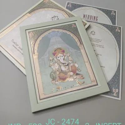 This premium invitation features a beautiful, framed illustration of Lord Ganesha, perfect for seeking blessings for your union. The card has a serene green color and includes two inserts.