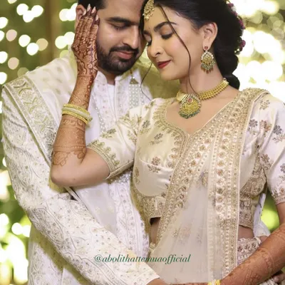 An intimate moment from a ring exchange ceremony. The groom's makeup is subtle, designed to even out his skin tone and keep him looking fresh for photos.