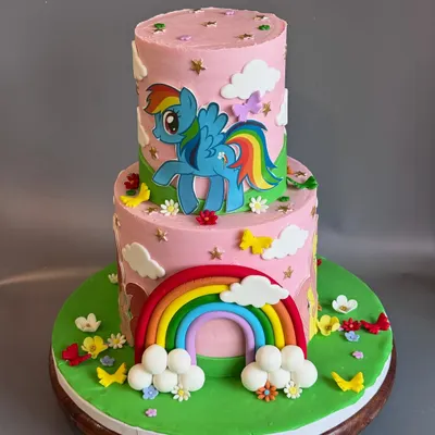 A full view of the dreamy 'My Little Pony' cake I made for Sara's 5th birthday. The two tiers provide a great canvas for telling a story with the colorful rainbow, fluffy clouds, and cute, handcrafted ponies.