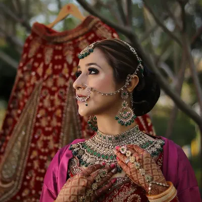 A breathtaking bridal look featuring intricate jewelry, a classic updo, and flawless makeup. The focus is on creating a timeless and elegant style for the big day.