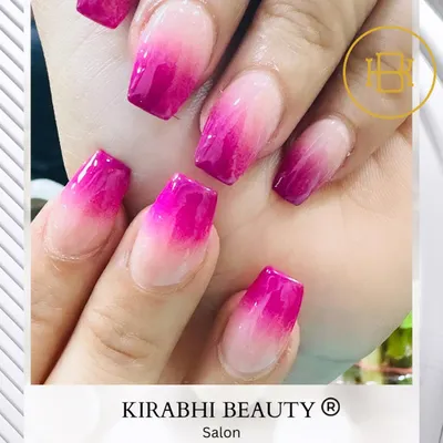 A beautiful example of ombre nails. This set features a smooth gradient that fades from a natural light pink at the cuticle to a vibrant magenta at the tip.