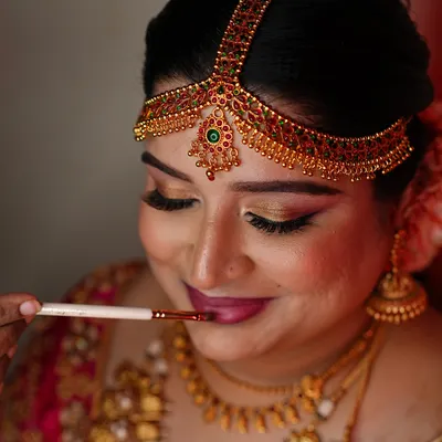 A close-up of the final touches. Applying lipstick is one of the last steps that brings the entire bridal look together. This is for Aishwarya's Brahmin wedding look.