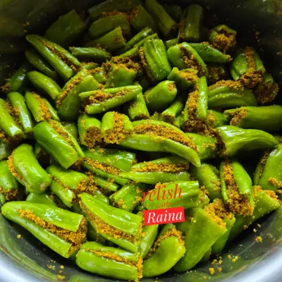 This is a close-up of my Stuffed Green Chilli Pickle before the oil is added. You can see how each chilli is carefully slit and filled with a freshly ground masala mix of mustard, fennel, and other spices.