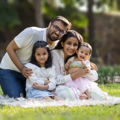 A picture-perfect moment of family joy. This outdoor session in a beautiful park setting captures the warmth and happiness of this family of four.