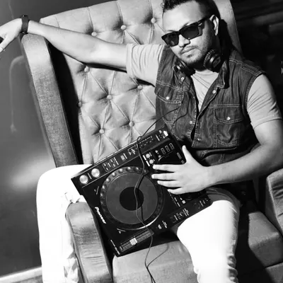 A black and white shot of me with my Pioneer DJ deck. This image captures my connection to the craft of DJing and music production, which has been my passion for years.