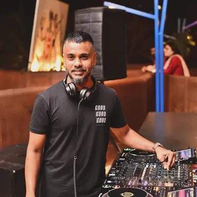 A portrait of me at my workstation. This is where the magic happens, where I prepare my sets and manage the flow of the night.