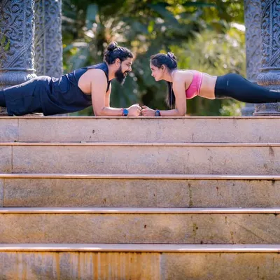 A couple that planks together, stays together. This fun fitness-themed shot on a set of stairs shows off the couple's strength and teamwork.
