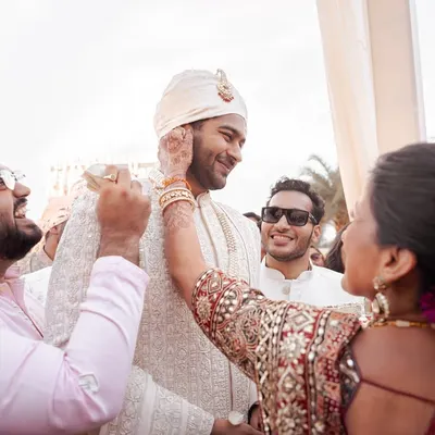 A mother's loving touch as she blesses her son on his wedding day. It's these candid, emotional interactions with family that form the heart of a wedding story.