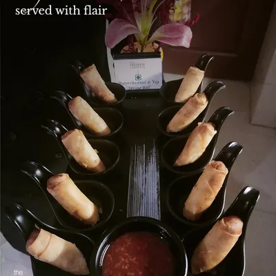 Crafted with care, served with flair. This image of elegantly presented spring rolls shows our attention to detail from the kitchen to the final presentation on your table.