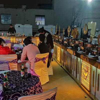 We work with top caterers to provide a delicious and beautifully presented feast for your guests. This image shows a lavish buffet setup at a wedding reception, ensuring your guests are well taken care of.