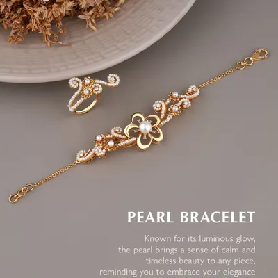 Let every movement shimmer with charm. The pearl, with its calming glow, pairs effortlessly with intricate goldwork in this bracelet and ring set. It is a delicate, romantic, and undeniably elegant design.