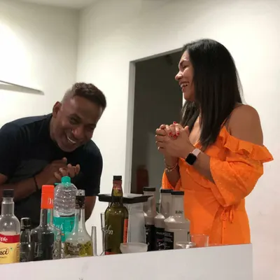 Sharing a laugh with a guest during a fun and interactive cocktail making session at a house party. These moments of joy and connection are what it's all about.