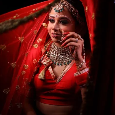 A stunning portrait of my Bengali bride. The traditional 'chandan' design on her forehead is beautifully complemented by the bold, defined eyes and red saree.