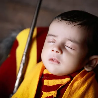A close-up of our Harry Potter theme, showing the baby peacefully sleeping with a wand. We pay close attention to every detail to make our creative themes authentic and magical.