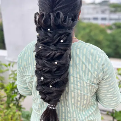 This intricate pull-through braid is a perfect example of the advanced, 'no-crimp' texturizing techniques I teach. The style creates amazing volume and is decorated with simple pearls.
