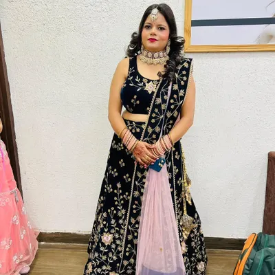 A full look at a client ready for a party or wedding, with professional makeup and curled hair styling.
