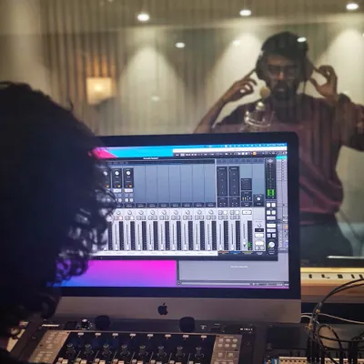 From the control room to the live room, our studio is ready for your next project. This image shows a recording session in progress, utilizing our professional-grade equipment.
