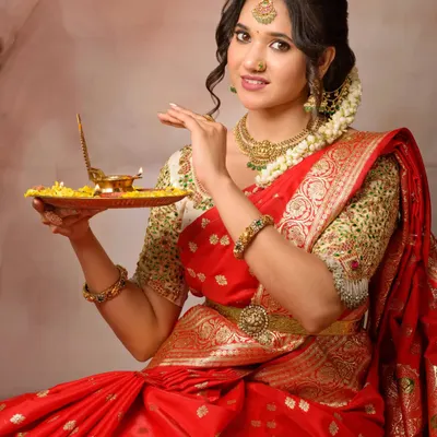A classic pose with a traditional puja thali during our Diwali-themed shoot. The warm lighting and festive props create an authentic and heartfelt image.