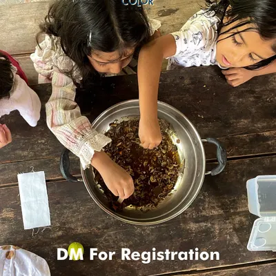 Two young girls get their hands messy while learning about natural dyes. Our workshops are a perfect activity for kids, allowing them to explore their creativity in a safe, eco-friendly environment.