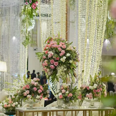 An abundance of pink and white roses creates a feeling of pure romance. We used these lush floral arrangements on guest tables and as statement pieces throughout the venue to build a cohesive and beautiful environment.