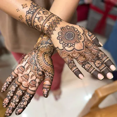 A gorgeous engagement mehendi for a dear friend. This design features a prominent mandala on the back of the hand, with delicate patterns extending up the arm, leaving some skin showing for a balanced look.