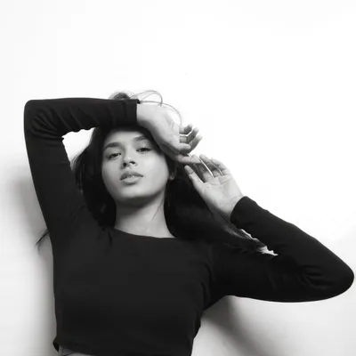 A beautiful black and white conversion of a studio portrait. The lack of color emphasizes the model's expression and the soft, natural light.