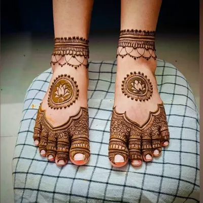A simple yet elegant feet design featuring a lotus mandala in the center, with a delicate chain-like pattern around the ankles.