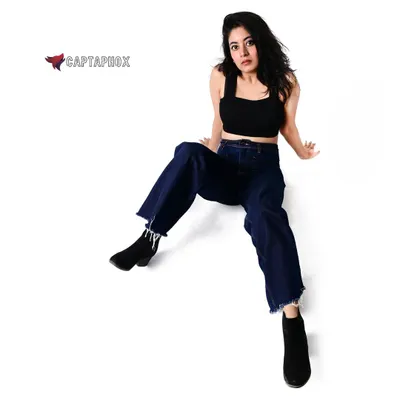 A full-length studio fashion shot on a clean white background. This high-angle perspective is great for showcasing an entire outfit and creating a dynamic pose for a model's portfolio.