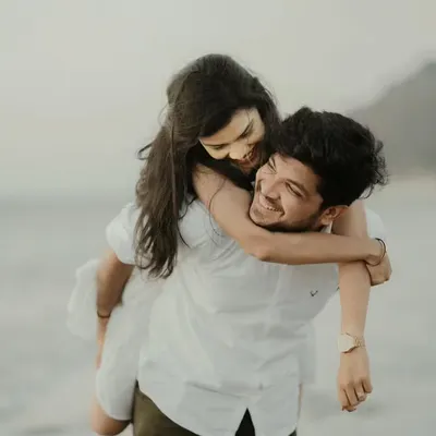 A perfect example of a candid beach photoshoot. The pure happiness in this piggyback ride against the soft light of the sea is what makes a pre-wedding session so special.