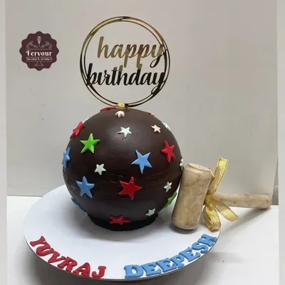 A classic chocolate piñata cake, perfect for any birthday. The chocolate sphere is decorated with colorful stars and comes with a wooden hammer to smash and reveal the goodies hidden inside.
