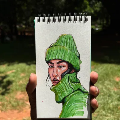 A finished portrait held up outdoors to show the true, vibrant colors. This hand-drawn illustration was made with alcohol markers, which are perfect for creating rich, saturated looks.