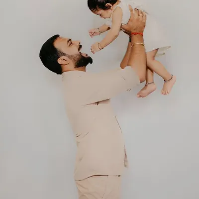 A joyful and candid moment between a father and his baby. I love capturing these simple, powerful expressions of love in my family photoshoots.