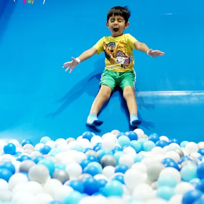 A perfect action shot of a child launching into our sea of blue and white balls! This is the peak moment of joy that our slides and ball pits deliver every single time.