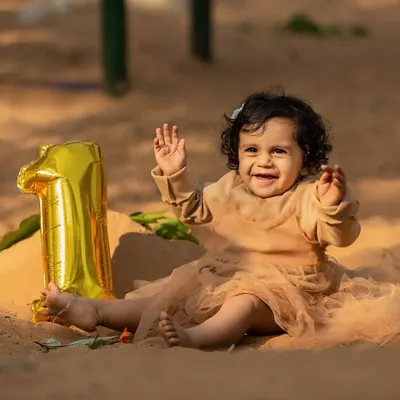 Celebrating one year of life with an outdoor session. This little one was so happy to play in the sand, and the simple '1' balloon marks the occasion perfectly while letting her personality be the main focus.