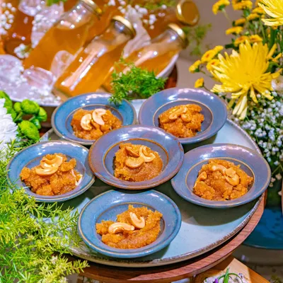 A close-up of a traditional Indian sweet, Moong Dal Halwa, served in small blue bowls as part of our Ganesh Chaturthi festive spread.