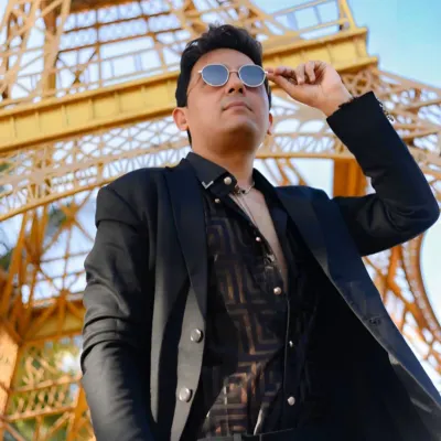 A stylish solo portrait with a low-angle shot against a replica of the Eiffel Tower. This kind of creative angle can make a portrait stand out.