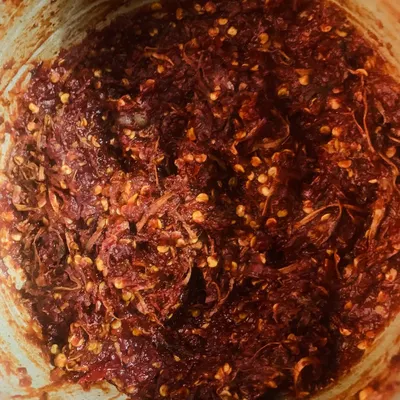 This is Etsu Molu, our traditional red chilli chutney. It's fiery and full of flavour, made by pounding together fresh king chillies, garlic, and other spices. A little bit of this goes a long way to spice up any meal.