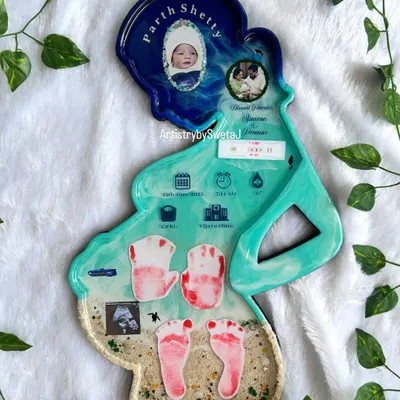 This is my "Motherhood Special" keepsake, shaped in the silhouette of an expecting mother. It holds the entire story: birth stats, the first ultrasound, baby's handprints and footprints, and photos of the newborn and parents.