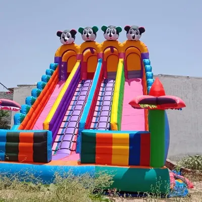 A clear, front-on view of the colorful four-lane Mickey Mouse inflatable slide. You can see the detailed construction, the climbing grips on the ladder, and the vibrant design that kids love.