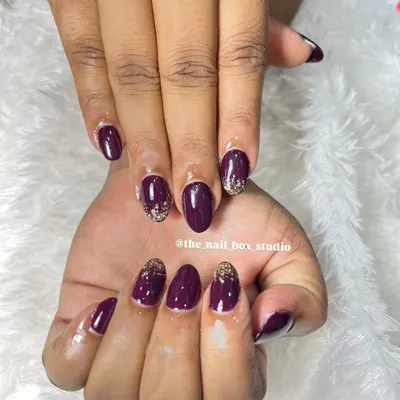 A beautiful set of soft gel extensions with a deep plum gel polish. I added a touch of gold glitter at the cuticles for a reverse glitter ombré effect, which adds a bit of sparkle and elegance.