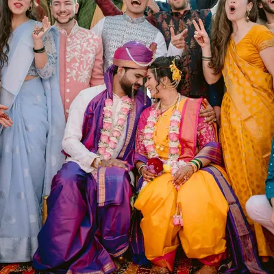 The best celebrations are shared with friends and family. This fun group shot captures the couple surrounded by the joyous energy of their loved ones during their wedding in Satara.