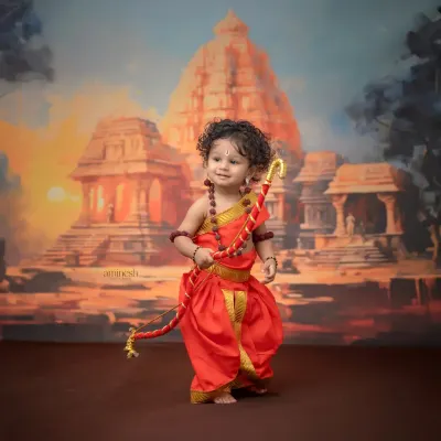 A full-view shot of the little Rama standing proudly with his bow against a grand temple backdrop. This photo captures the divine and heroic spirit of the theme.
