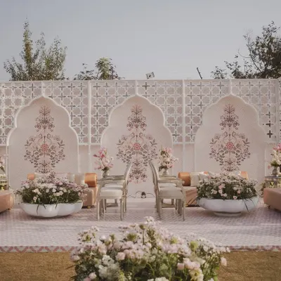 We created a modern 'Mughal Garden' for this Jaipur wedding, using a soothing palette, intricate backdrops, and lush florals to evoke palatial elegance.