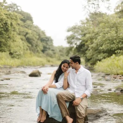 A quiet moment of togetherness, sitting on a rock in a gentle river. This natural light pre-wedding shoot is for couples who find romance in the simplicity and beauty of the outdoors.