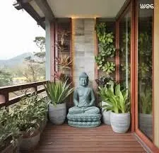 We designed this peaceful balcony corner for meditation and quiet time. It features a Buddha statue, easy to care for plants in modern pots, and a vertical garden wall to make the small space feel lush and private.