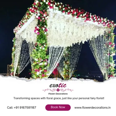 A wedding mandap that feels like a dream. We constructed this stunning structure with pillars of fresh greenery and roses, crowned with a canopy of delicate hanging florals for a truly magical ceremony.